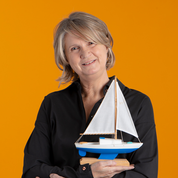 Lynn Giles holding a sail boat