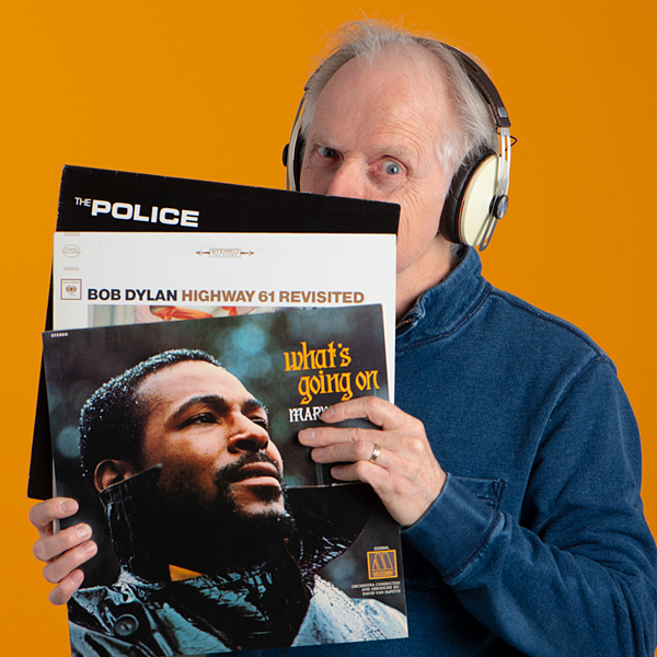 Photo of Mark Willard holding vinyl records