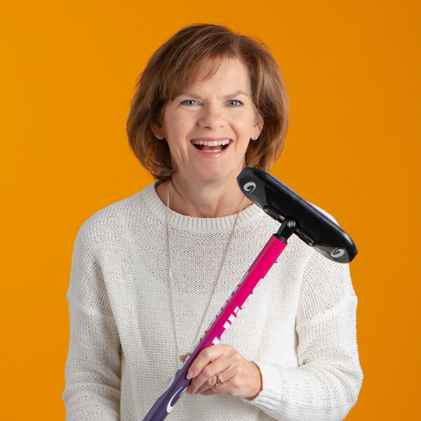 Diane smiling holding a brush