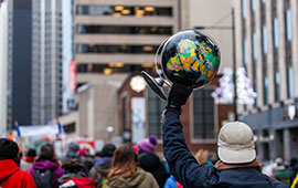 Protestor Holding Globe