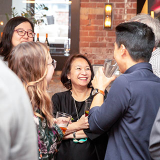 SLD employees laughing and drinking