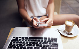 Woman with iPhone and MacBook