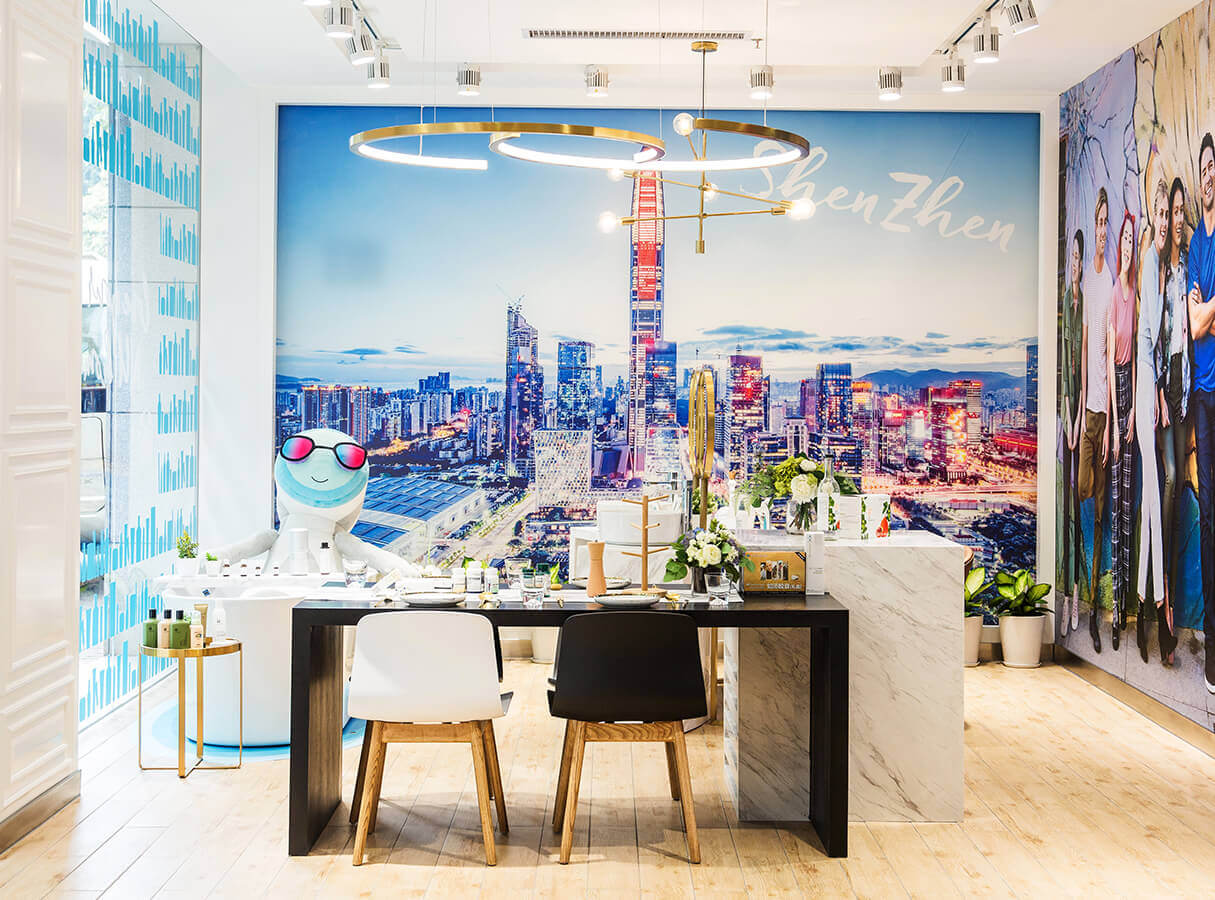 interior of nu skin store with desk, chairs and a large photo of Shenzhen