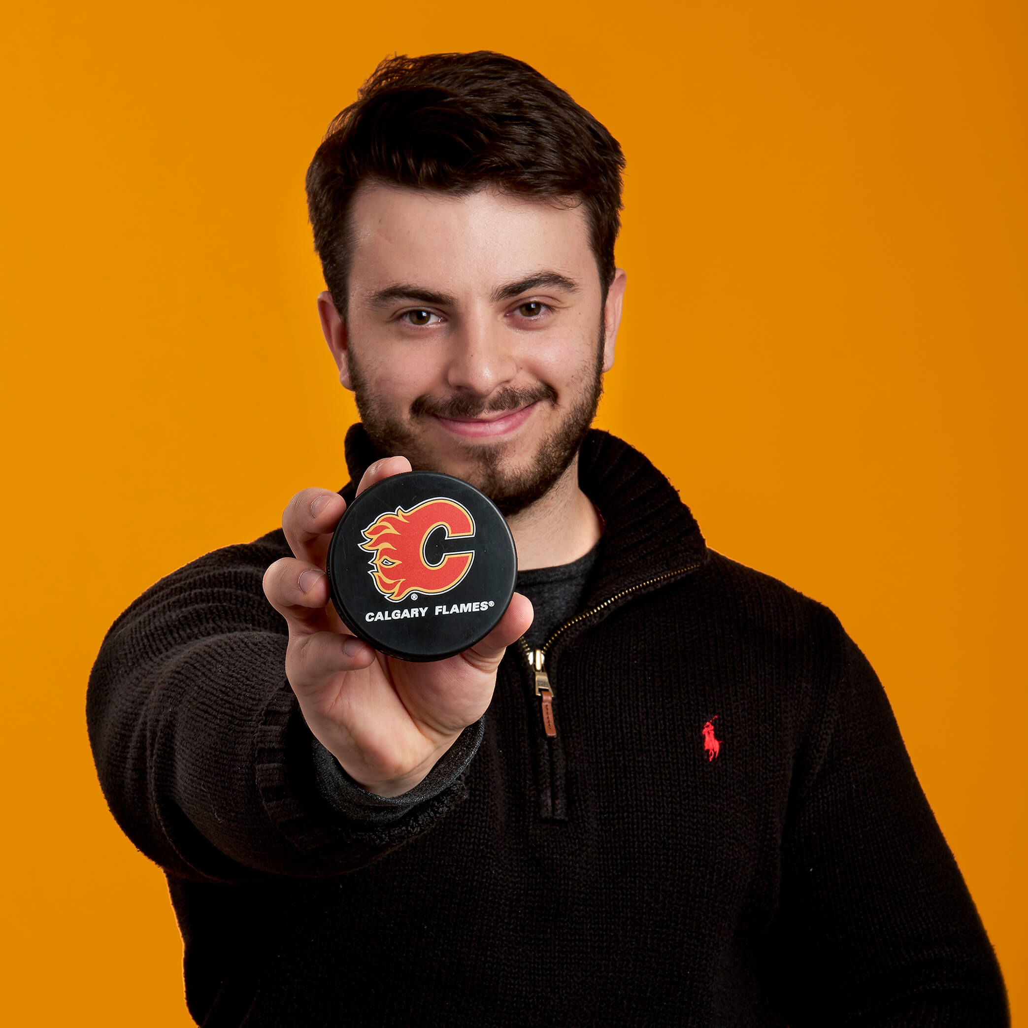 Matthew holding Calgary Flames puck