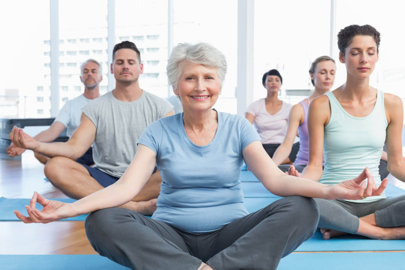 People doing yoga in lotus pose