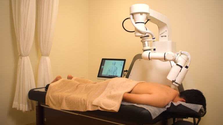 man receiving massage from robot