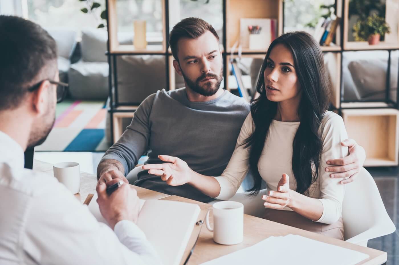 couple getting financial advice at a desk with a bank advisor