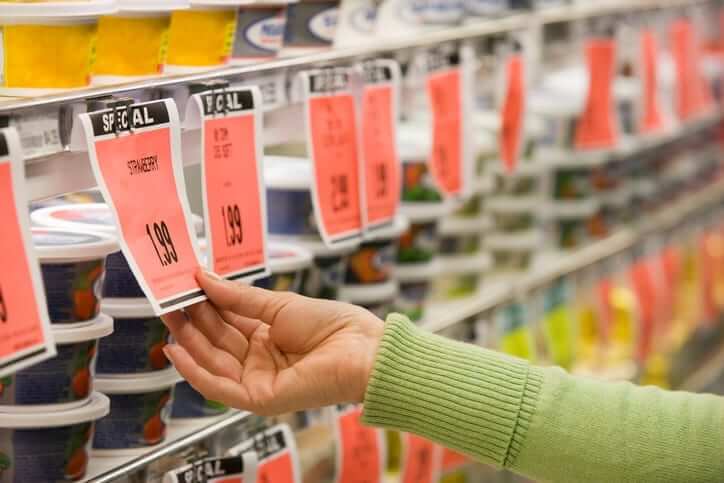 Woman checking clearly labeled retail price stickers